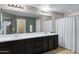 Spacious bathroom with double sink vanity, large mirror, and neutral color scheme at 41311 W Elm Dr, Maricopa, AZ 85138