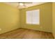 Bedroom with yellow walls, ceiling fan, and window with blind at 41373 W Coltin Way, Maricopa, AZ 85138