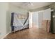 Bedroom with pale green walls, tile flooring and wardrobe at 41373 W Coltin Way, Maricopa, AZ 85138
