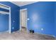 Bedroom with blue walls and laminate flooring featuring a closet and doorways at 41373 W Coltin Way, Maricopa, AZ 85138