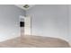 A bright and empty bedroom with new laminate floors and a view of the hall at 41373 W Coltin Way, Maricopa, AZ 85138