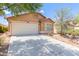 Single-story home featuring a two-car garage and desert landscaping at 41373 W Coltin Way, Maricopa, AZ 85138