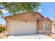 Single-story house featuring a two-car garage and desert landscaping at 41373 W Coltin Way, Maricopa, AZ 85138