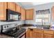 A close up of the range, sink and countertops in the kitchen area at 41373 W Coltin Way, Maricopa, AZ 85138