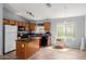 Kitchen featuring a functional island, wooden cabinets, and essential modern appliances at 41373 W Coltin Way, Maricopa, AZ 85138