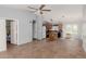 A spacious kitchen features wood cabinets, an island, tile floors, and modern appliances at 41373 W Coltin Way, Maricopa, AZ 85138