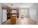 The kitchen boasts wood cabinets, black appliances, a window and a functional center island at 41373 W Coltin Way, Maricopa, AZ 85138