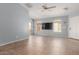 Spacious living room with tile floors, ceiling fan, and bright natural light at 41373 W Coltin Way, Maricopa, AZ 85138
