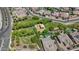 Aerial view of a community park with playground equipment and shade, surrounded by well-kept homes and landscaping at 4671 N 185Th Ln, Goodyear, AZ 85395