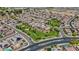 The aerial shows the community green spaces, park, and well maintained homes in a Gathering friendly neighborhood at 4671 N 185Th Ln, Goodyear, AZ 85395