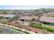 An aerial view shows the spacious backyard with gravel landscaping and artificial turf accentuating the home's exterior at 4671 N 185Th Ln, Goodyear, AZ 85395