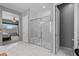 Modern bathroom with a glass-enclosed shower, dual vanities, and tile flooring at 4671 N 185Th Ln, Goodyear, AZ 85395