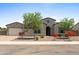 Charming single-story home with desert landscaping, a two-car garage and an arched entryway at 4671 N 185Th Ln, Goodyear, AZ 85395