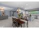 Open-concept kitchen with white cabinets, a center island, and a dining area with pendant lighting at 4671 N 185Th Ln, Goodyear, AZ 85395