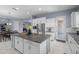 Bright kitchen with white cabinets, granite countertops, and stainless steel appliances and large center island at 4671 N 185Th Ln, Goodyear, AZ 85395