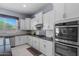 Modern kitchen showcasing stainless steel appliances, ample white cabinetry, and granite countertops at 4671 N 185Th Ln, Goodyear, AZ 85395