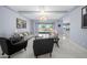 Bright living room features modern decor, tile floors, a backyard view through sliding glass doors and neutral paint at 4671 N 185Th Ln, Goodyear, AZ 85395