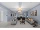 Living room showcasing neutral paint, tile flooring, modern decor and abundant natural light at 4671 N 185Th Ln, Goodyear, AZ 85395