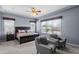 Cozy main bedroom with neutral colors, a ceiling fan, and large windows for natural light at 4671 N 185Th Ln, Goodyear, AZ 85395
