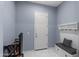 Light blue mud room with tiled floor, closet, coat rack and bench, providing convenient storage at 4671 N 185Th Ln, Goodyear, AZ 85395