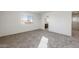 Bright bedroom featuring neutral carpet, white walls and trim, and a sunlit window at 5041 S 252Nd Ave, Buckeye, AZ 85326