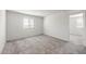 Bedroom features neutral carpet, white walls, a window, and access to other areas at 5041 S 252Nd Ave, Buckeye, AZ 85326