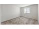 Bedroom features neutral carpet, white walls, and a bright, sunlit window at 5041 S 252Nd Ave, Buckeye, AZ 85326