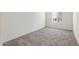 Bright bedroom with neutral carpet, white walls, a window, and an electrical outlet visible at 5041 S 252Nd Ave, Buckeye, AZ 85326