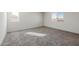 Bright bedroom featuring neutral carpet, white walls and trim, and dual sunlit windows at 5041 S 252Nd Ave, Buckeye, AZ 85326