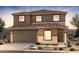 Charming two-story home features a two-car garage, tiled roof, and desert landscaping for a clean, modern aesthetic at 5041 S 252Nd Ave, Buckeye, AZ 85326