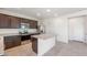 Bright kitchen features dark wood cabinets, granite countertops, stainless steel appliances, and a spacious kitchen island at 5041 S 252Nd Ave, Buckeye, AZ 85326