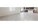 Open-concept living space with tile flooring, leading to a modern kitchen with stainless steel appliances at 5041 S 252Nd Ave, Buckeye, AZ 85326