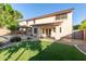 A delightful backyard with pergola, manicured lawn, and access to the house creating a perfect outdoor retreat at 5754 W Larkspur Dr, Glendale, AZ 85304
