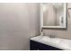 Powder room with a stylish vanity, granite countertop, modern sink, and decorative soap dispenser at 5754 W Larkspur Dr, Glendale, AZ 85304