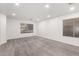 Bedroom with plush carpet, bright lighting, and windows with neutral blinds at 5754 W Larkspur Dr, Glendale, AZ 85304