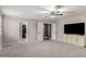 Large bedroom with neutral walls, plush carpet, ceiling fan, and closet access at 5754 W Larkspur Dr, Glendale, AZ 85304