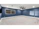 Navy bedroom featuring ceiling fan, white trim, and vinyl flooring at 5754 W Larkspur Dr, Glendale, AZ 85304