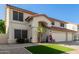 Charming two-story home with a three-car garage, desert landscaping, and a red tile roof at 5754 W Larkspur Dr, Glendale, AZ 85304