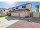 Charming two-story home with a three-car garage, desert landscaping, and a red tile roof at 5754 W Larkspur Dr, Glendale, AZ 85304
