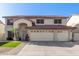 Charming two-story home with a three-car garage, desert landscaping, and a red tile roof at 5754 W Larkspur Dr, Glendale, AZ 85304