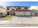 Charming two-story home with a three-car garage, desert landscaping, and a red tile roof at 5754 W Larkspur Dr, Glendale, AZ 85304