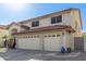 Charming two-story home with a three-car garage, desert landscaping, and a red tile roof at 5754 W Larkspur Dr, Glendale, AZ 85304