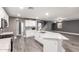 Bright, open kitchen featuring white cabinets, stainless steel appliances, granite countertops, and an island with sink at 5754 W Larkspur Dr, Glendale, AZ 85304