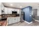 Bright kitchen with gray cabinets, stainless steel refrigerator, wooden countertops, and a mosaic tile backsplash at 5754 W Larkspur Dr, Glendale, AZ 85304