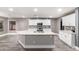 Open kitchen featuring white cabinets, granite countertops, stainless steel appliances, and a large island with a sink at 5754 W Larkspur Dr, Glendale, AZ 85304