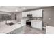 Modern kitchen with white cabinets, stainless steel appliances, granite countertops, and tile backsplash at 5754 W Larkspur Dr, Glendale, AZ 85304