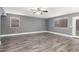 Bright, neutral living room with a ceiling fan, wood-look tile floors, and modern blinds at 5754 W Larkspur Dr, Glendale, AZ 85304