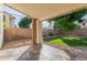 Enjoy a covered patio with stone flooring, and a view of the beautifully maintained lawn and backyard at 5754 W Larkspur Dr, Glendale, AZ 85304