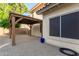 Charming backyard featuring a pergola and low maintenance landscaping, with a view of the house exterior at 5754 W Larkspur Dr, Glendale, AZ 85304