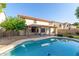 Inviting backyard featuring a sparkling pool, pergola, and meticulously maintained lawn for relaxation and entertainment at 5754 W Larkspur Dr, Glendale, AZ 85304
